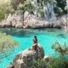 Woman sitting on rock at Calanque d'en Vau