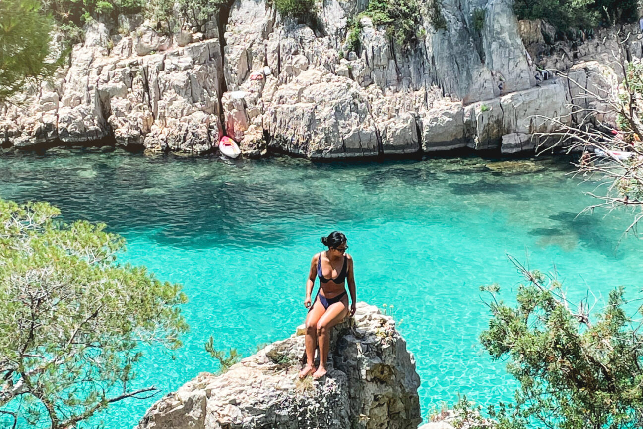 Woman sitting on rock at Calanque d'en Vau