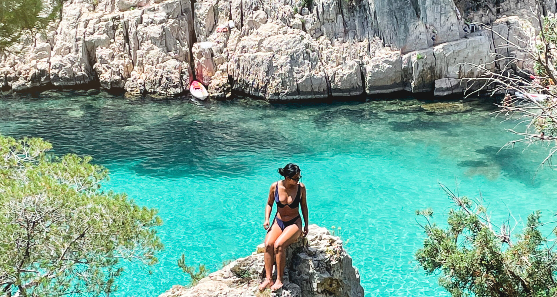 Woman sitting on rock at Calanque d'en Vau