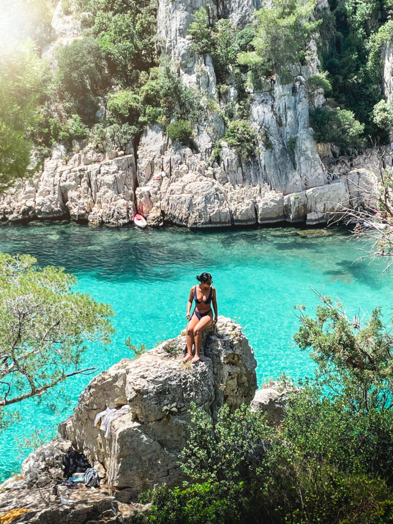 Woman sitting on rock at Calanque d'en Vau